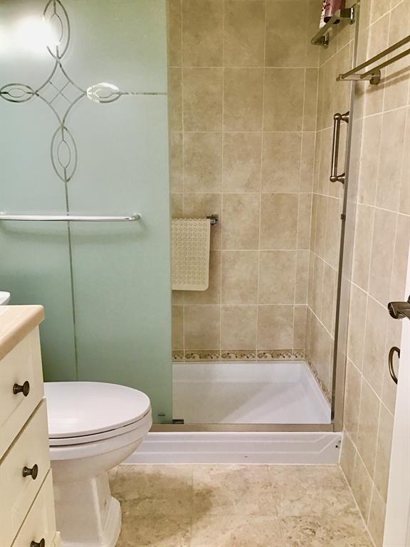2038 Exeter C, Unit 2038 Boca Raton, FL 33434 - Photo 15 of 37 a bathroom with a toilet and a shower