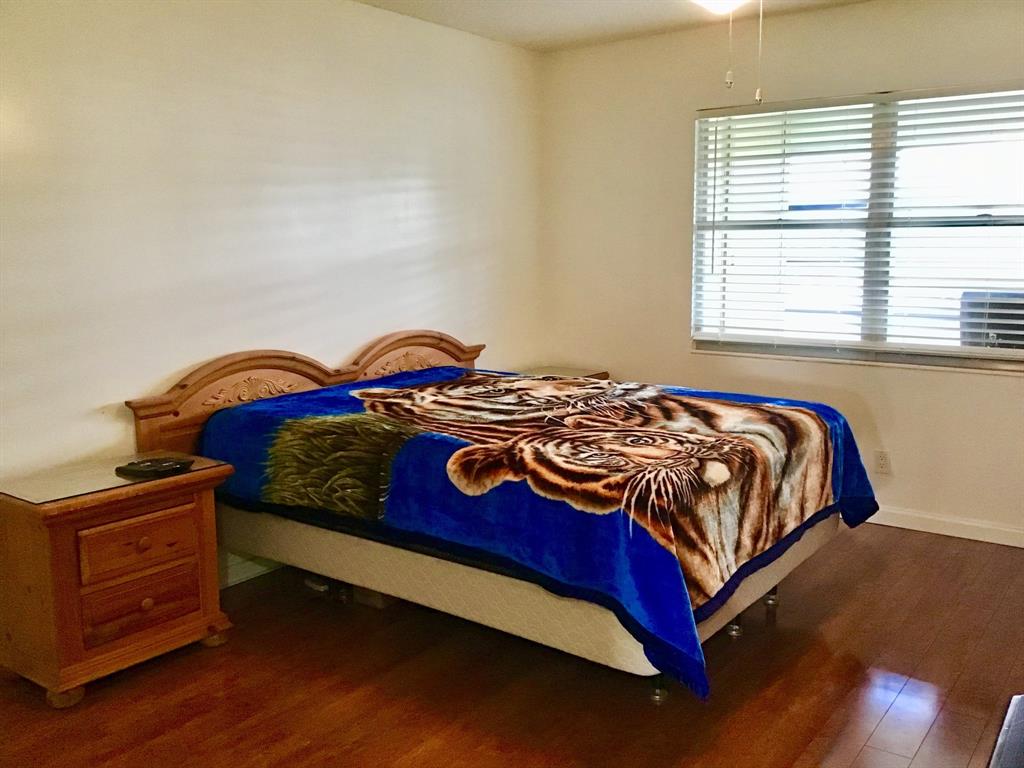 2038 Exeter C, Unit 2038 Boca Raton, FL 33434 - Photo 22 of 37 a bedroom with a bed and a window