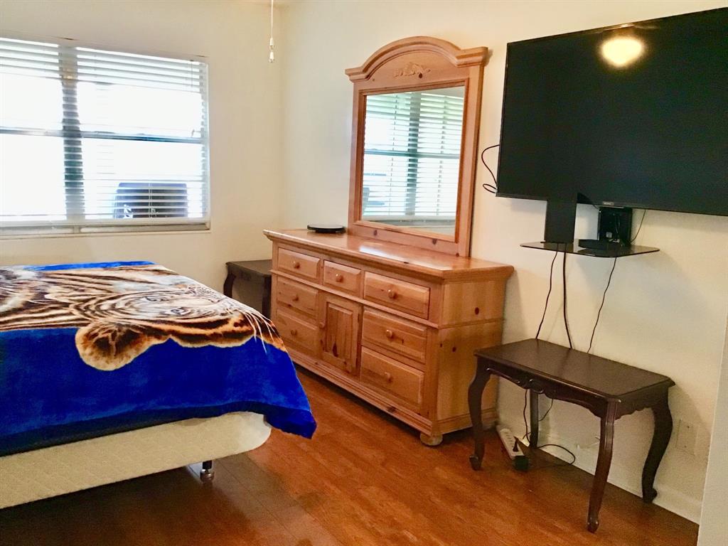 2038 Exeter C, Unit 2038 Boca Raton, FL 33434 - Photo 24 of 37 a bedroom with a bed and a window