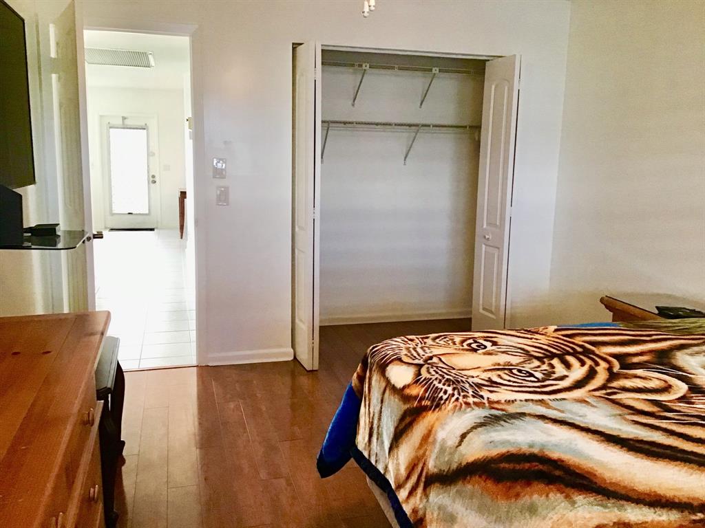 2038 Exeter C, Unit 2038 Boca Raton, FL 33434 - Photo 26 of 37 a bedroom with a bed and a mirror