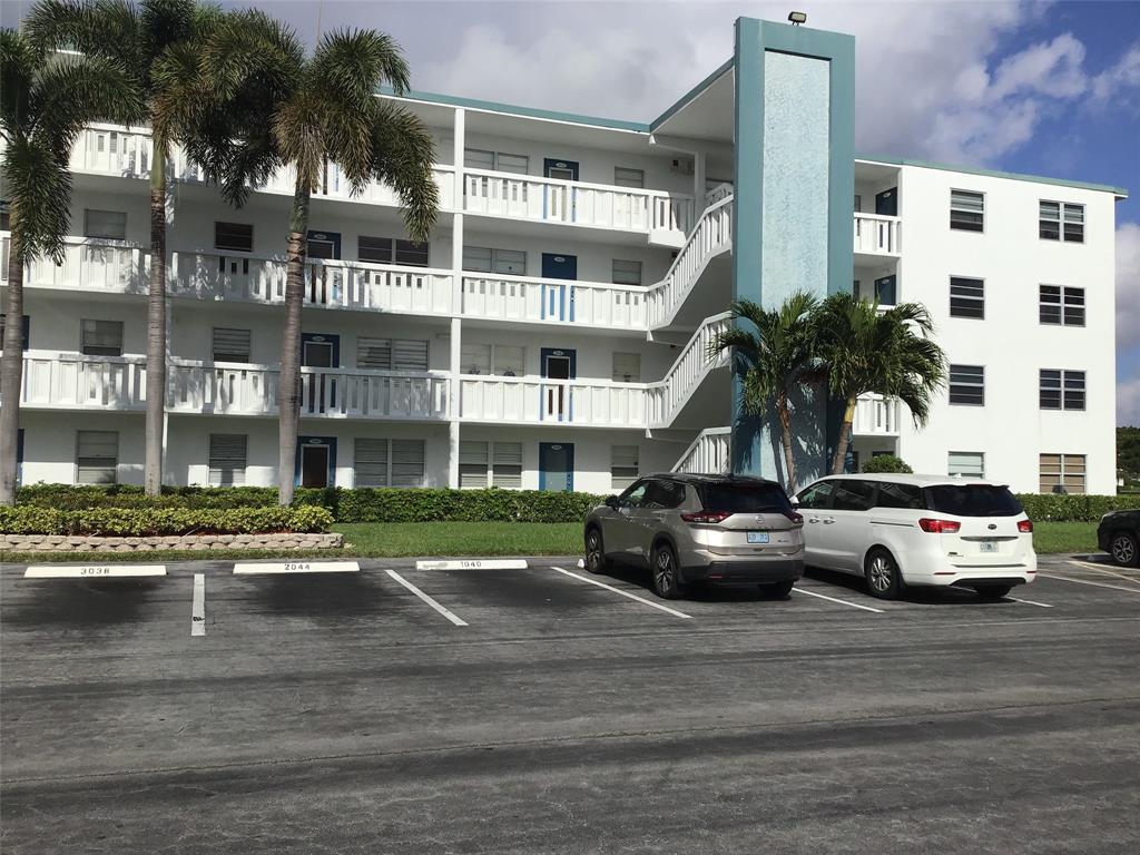 2038 Exeter C, Unit 2038 Boca Raton, FL 33434 - Photo 4 of 37 a view of a street that has couple of cars parked on road