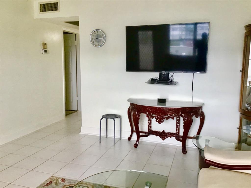 2038 Exeter C, Unit 2038 Boca Raton, FL 33434 - Photo 8 of 37 a bathroom with a sink and a mirror