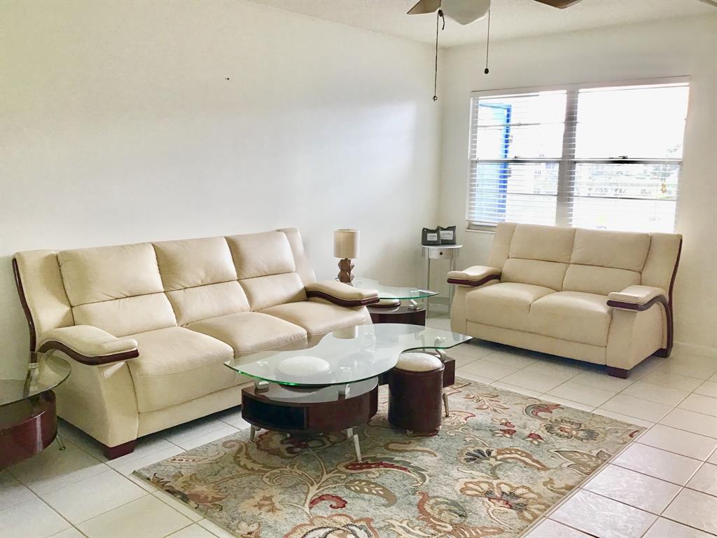 2038 Exeter C, Unit 2038 Boca Raton, FL 33434 - Photo 10 of 37 a living room with furniture and a window