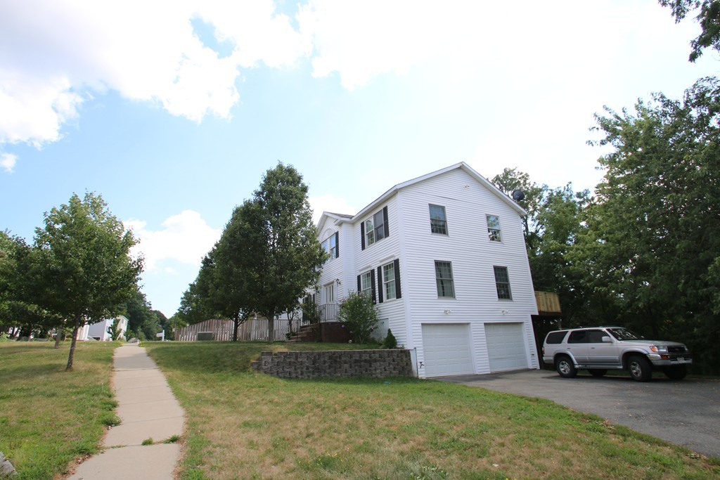301 Ridge Road, Unit A Revere, MA 02151 - Photo 2 of 27 a view of a white house with a big yard and large trees