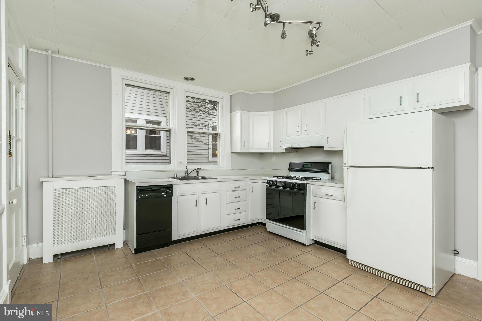 621 Deepdene Road Baltimore, MD 21210 - Photo 11 of 27 a kitchen with stainless steel appliances granite countertop a refrigerator and a stove top oven