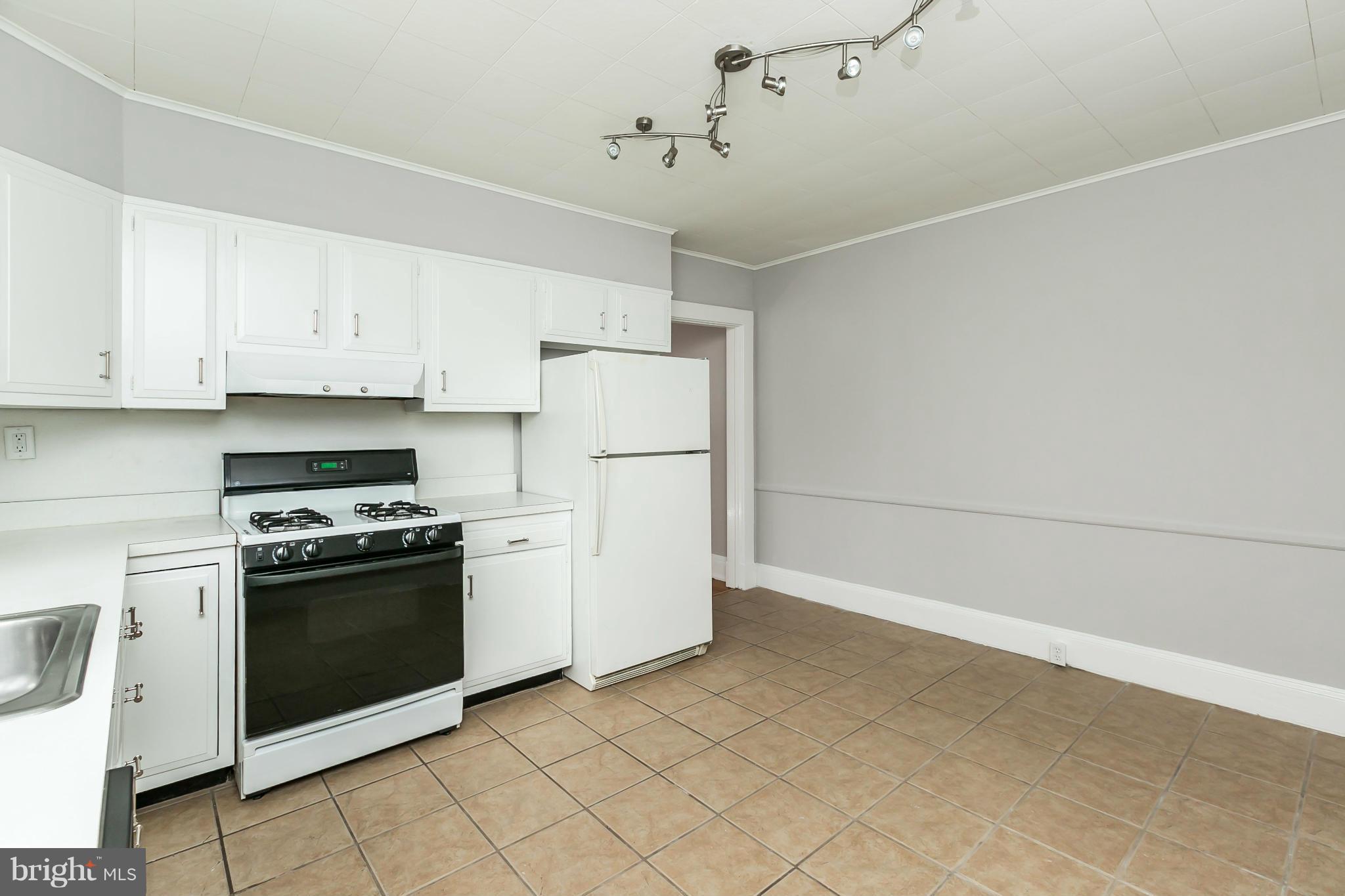621 Deepdene Road Baltimore, MD 21210 - Photo 12 of 27 a kitchen with cabinets and white stainless steel appliances