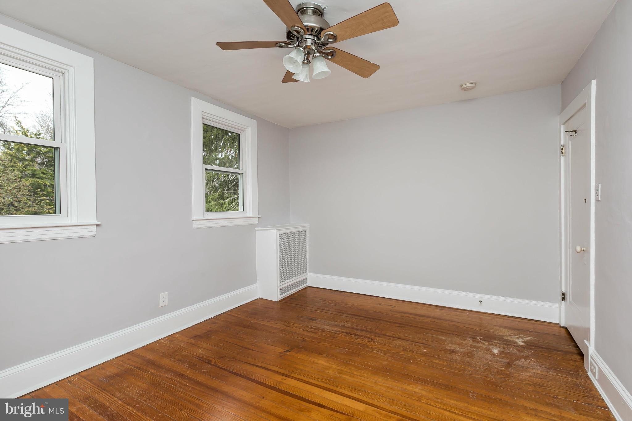621 Deepdene Road Baltimore, MD 21210 - Photo 15 of 27 wooden floor in an empty room with a window