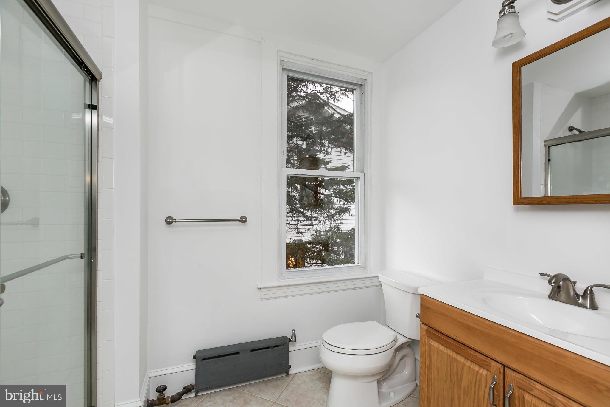 621 Deepdene Road Baltimore, MD 21210 - Photo 18 of 27 a bathroom with a sink toilet and window