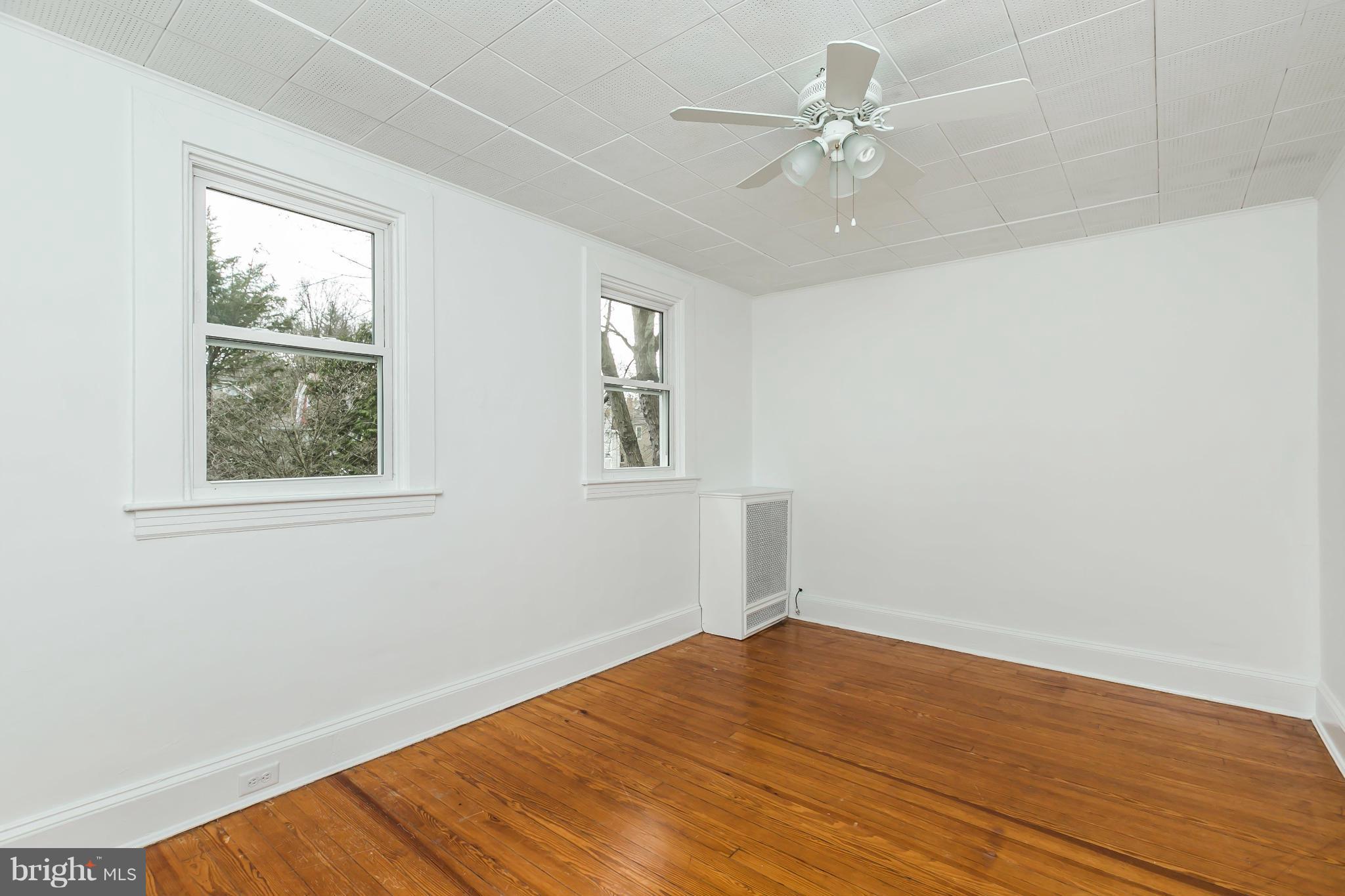 621 Deepdene Road Baltimore, MD 21210 - Photo 19 of 27 wooden floor in an empty room with a window