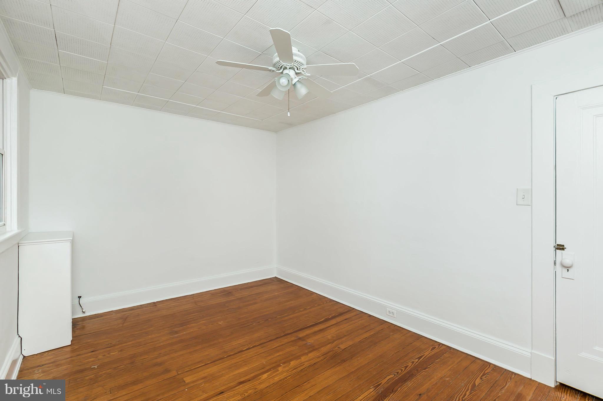 621 Deepdene Road Baltimore, MD 21210 - Photo 21 of 27 an empty room with wooden floor and fan