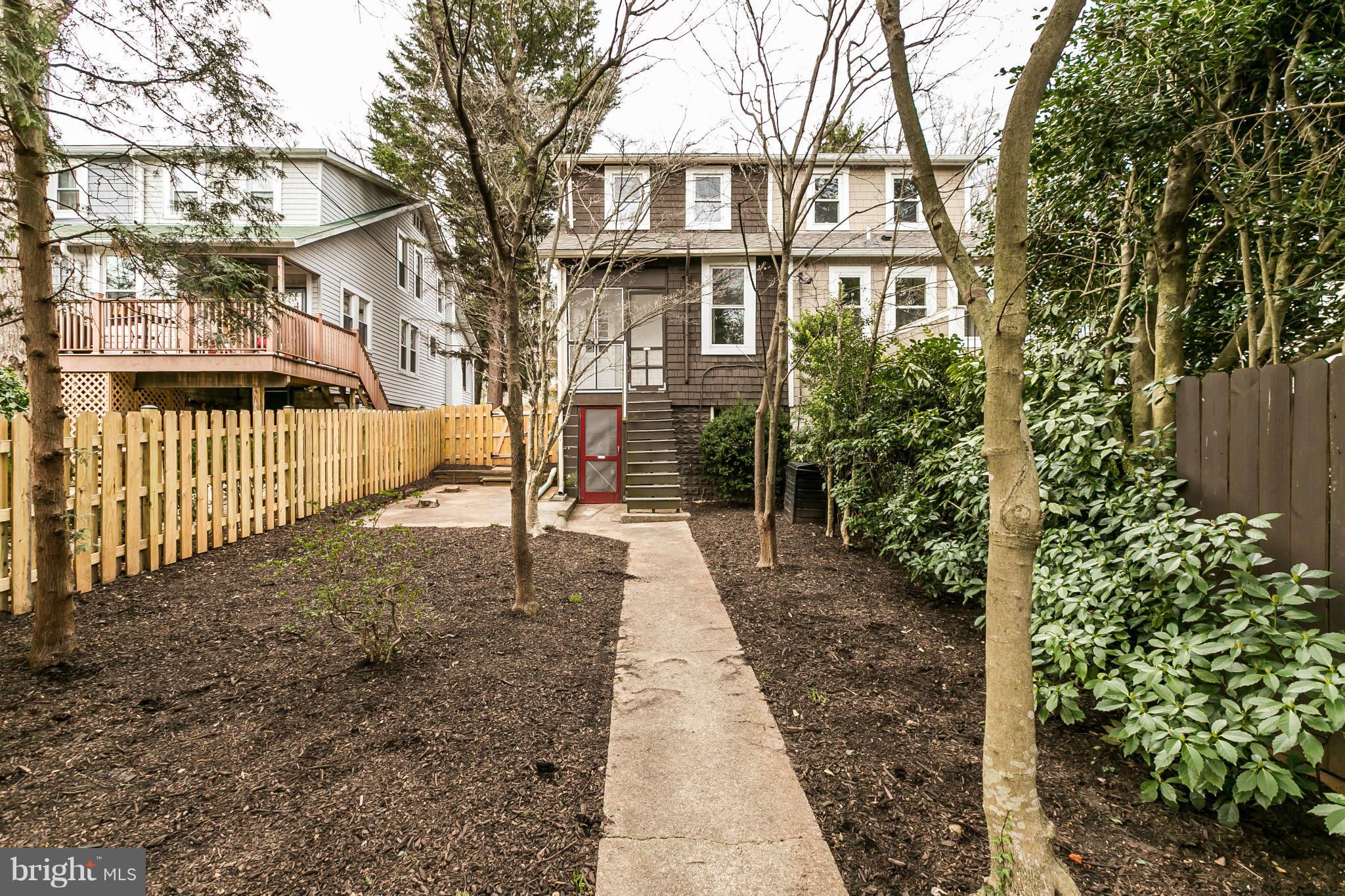 621 Deepdene Road Baltimore, MD 21210 - Photo 26 of 27 a view of a brick house with many windows next to a yard