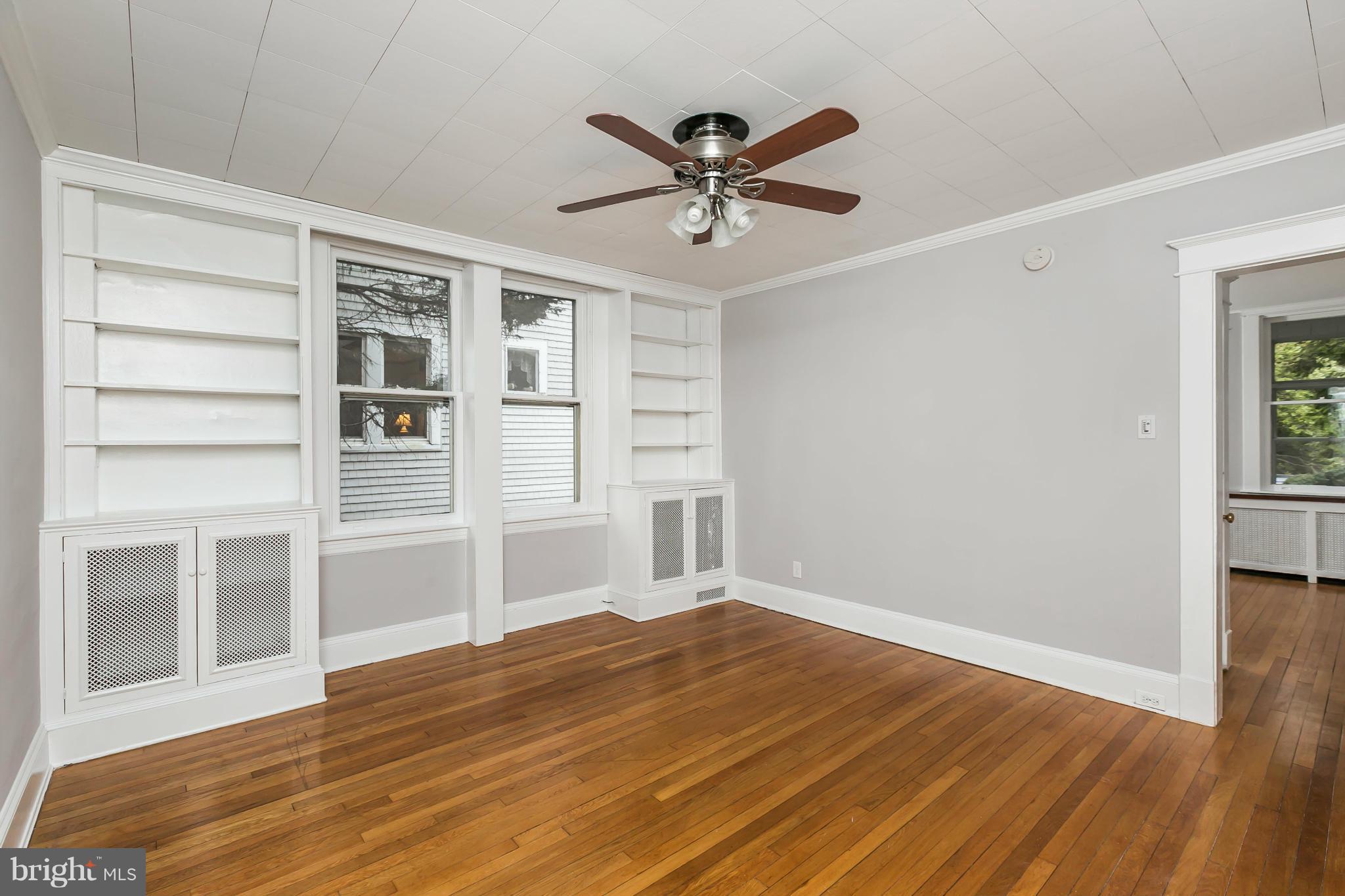 621 Deepdene Road Baltimore, MD 21210 - Photo 7 of 27 a view of a livingroom with wooden floor and a ceiling fan