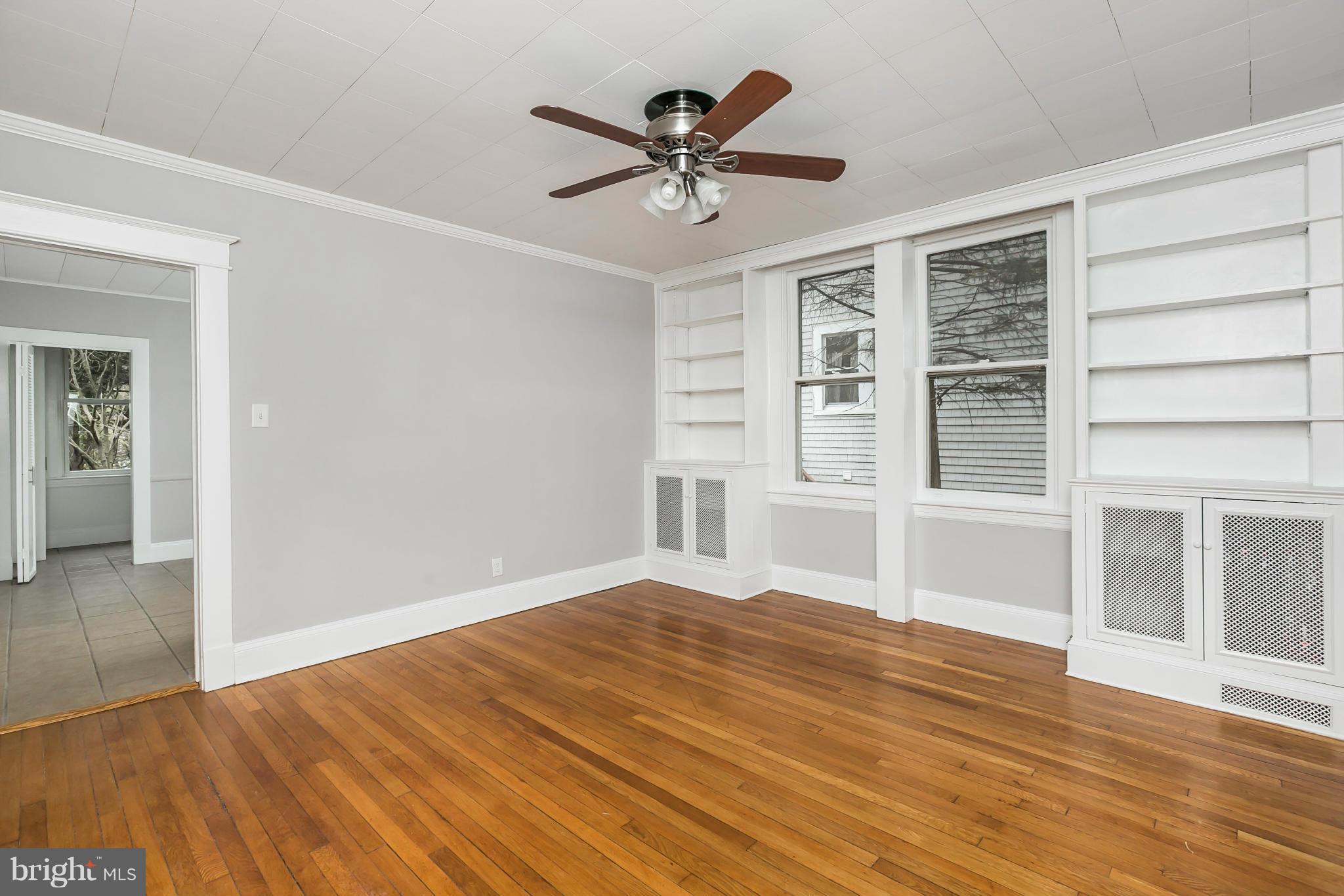 621 Deepdene Road Baltimore, MD 21210 - Photo 8 of 27 a view of a livingroom with wooden floor and a ceiling fan