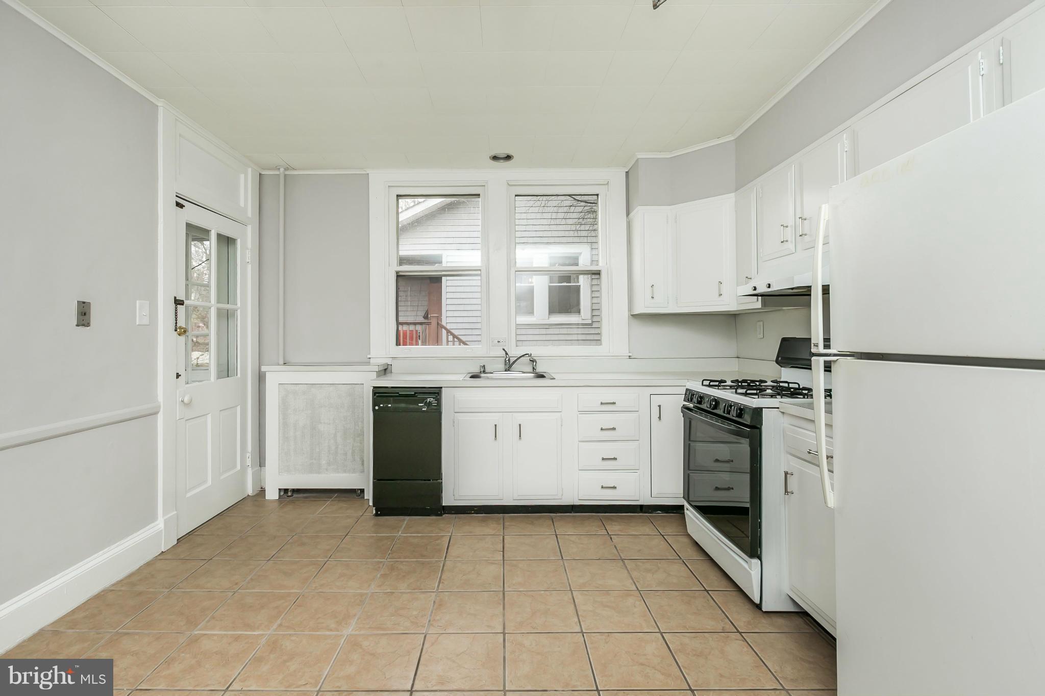 621 Deepdene Road Baltimore, MD 21210 - Photo 10 of 27 a kitchen with a stove sink and a refrigerator