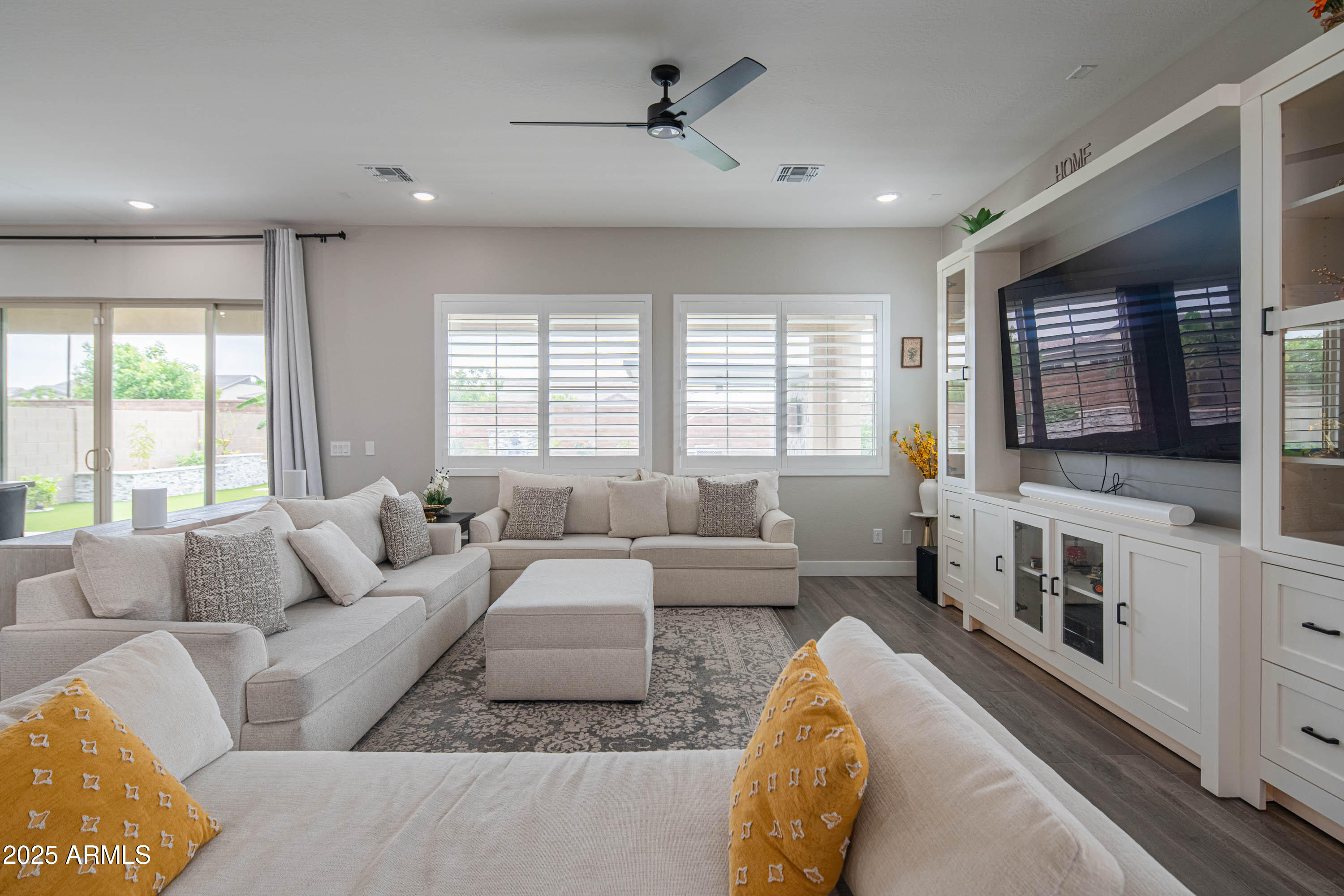 5232 South Cobblestone Street Gilbert, AZ 85298 - Photo 11 of 71 a living room with furniture and a flat screen tv