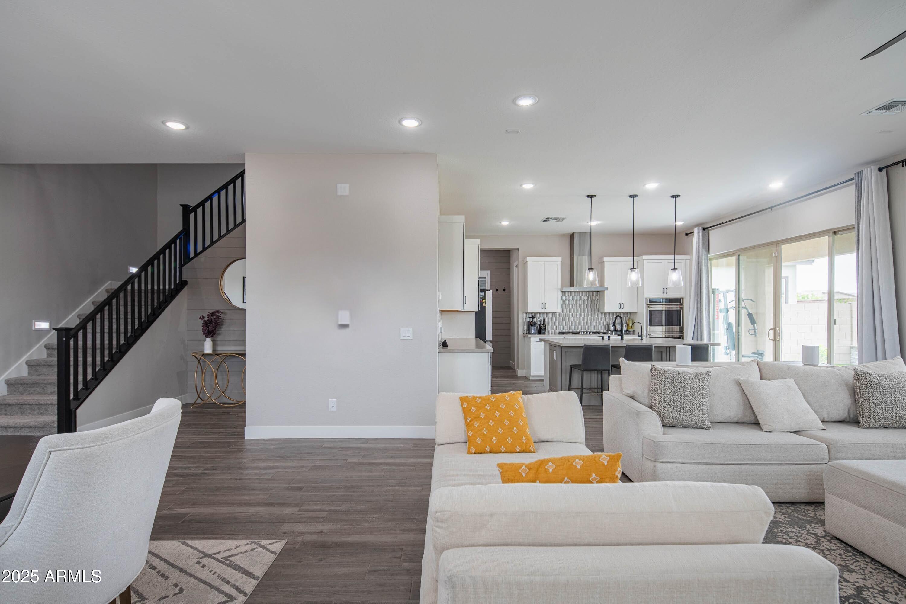 5232 South Cobblestone Street Gilbert, AZ 85298 - Photo 12 of 71 a living room with furniture and wooden floor