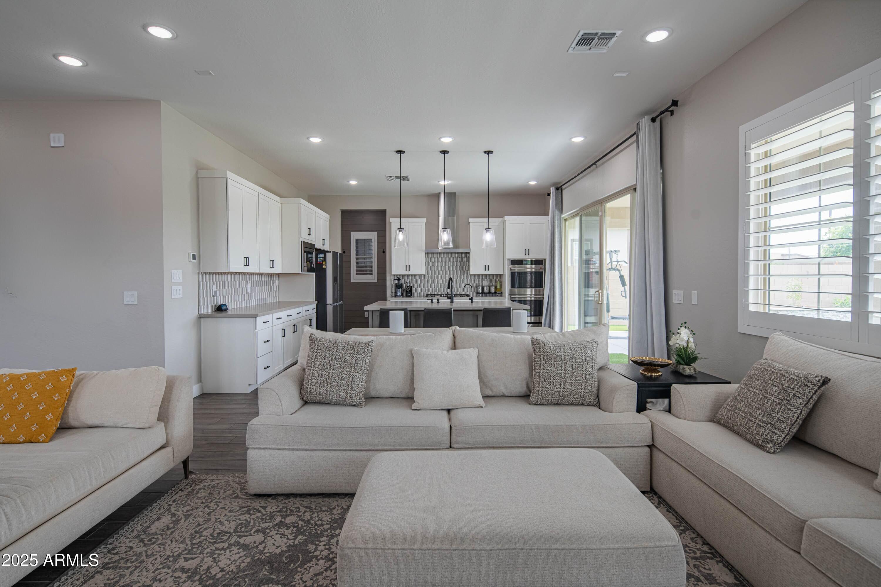 5232 South Cobblestone Street Gilbert, AZ 85298 - Photo 15 of 71 a living room with furniture and kitchen view