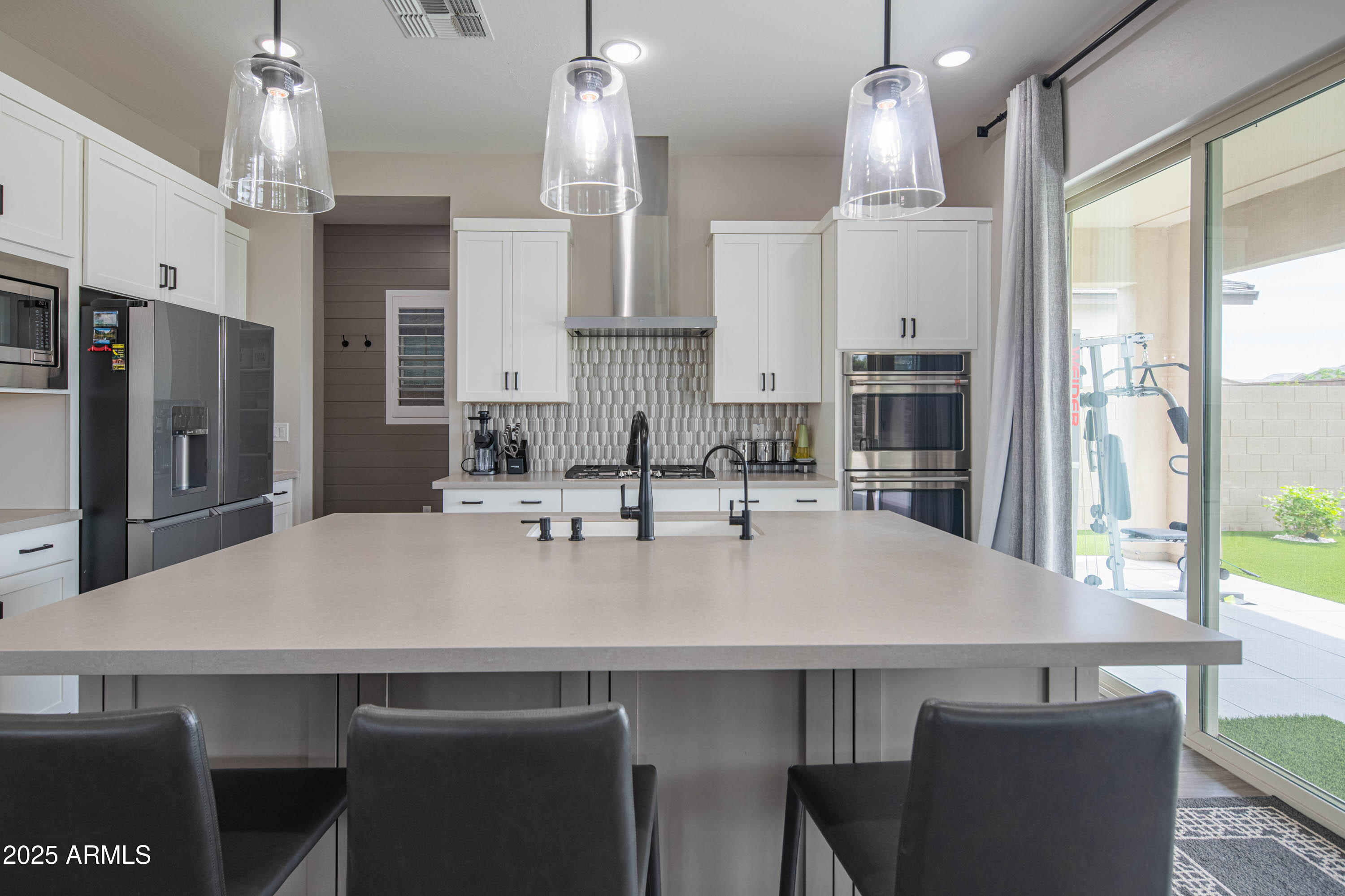 5232 South Cobblestone Street Gilbert, AZ 85298 - Photo 17 of 71 a kitchen with stainless steel appliances a sink stove and refrigerator