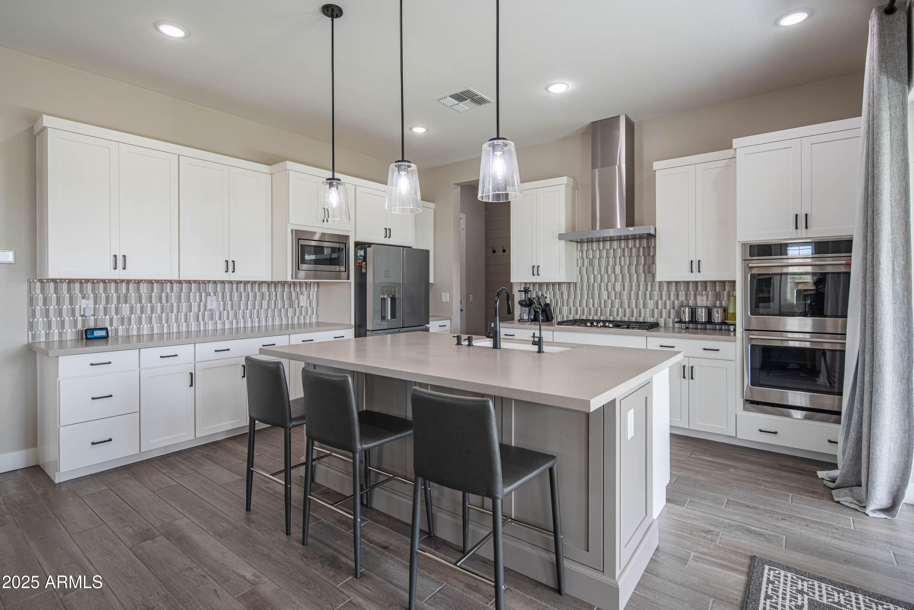 5232 South Cobblestone Street Gilbert, AZ 85298 - Photo 18 of 71 a kitchen with a sink center island stainless steel appliances and cabinets