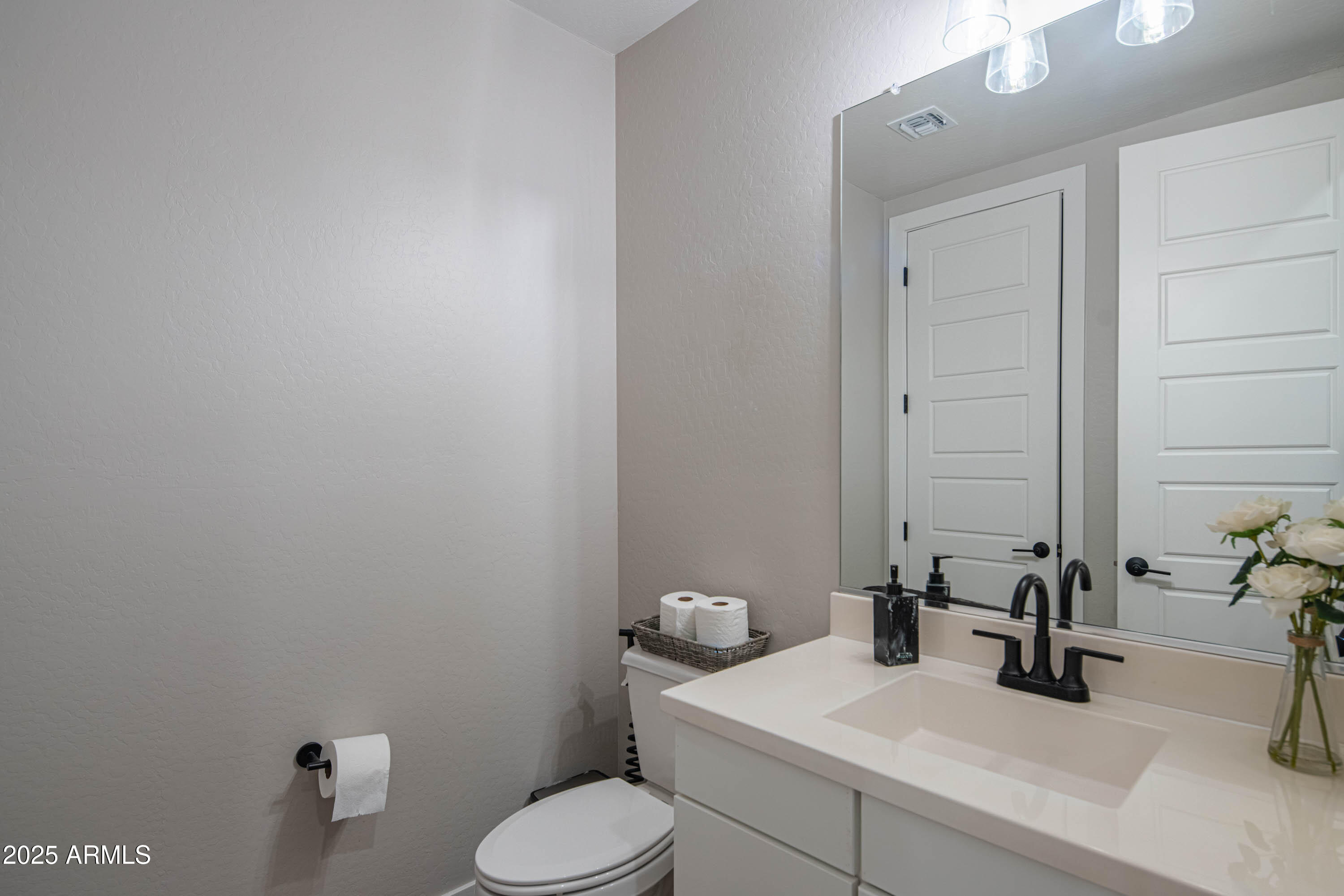 5232 South Cobblestone Street Gilbert, AZ 85298 - Photo 25 of 71 a bathroom with a toilet sink and mirror