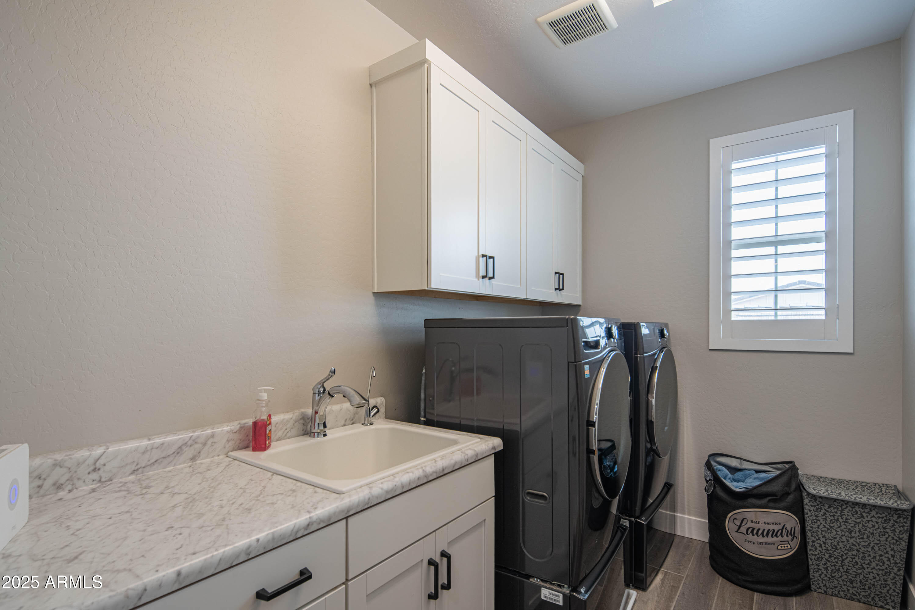 5232 South Cobblestone Street Gilbert, AZ 85298 - Photo 31 of 71 a utility room with a sink dryer and washer