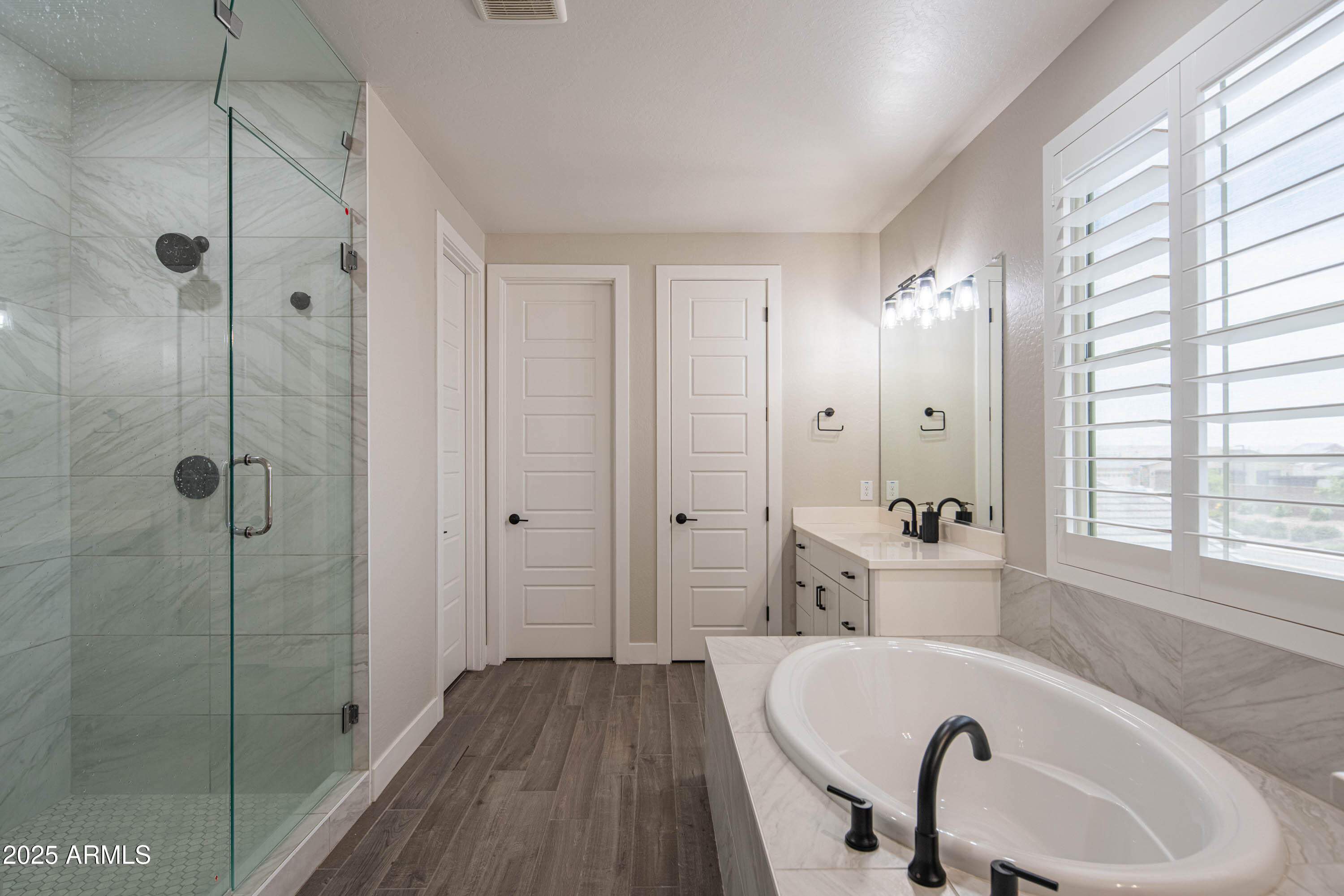 5232 South Cobblestone Street Gilbert, AZ 85298 - Photo 36 of 71 a bathroom with a bathtub and a shower