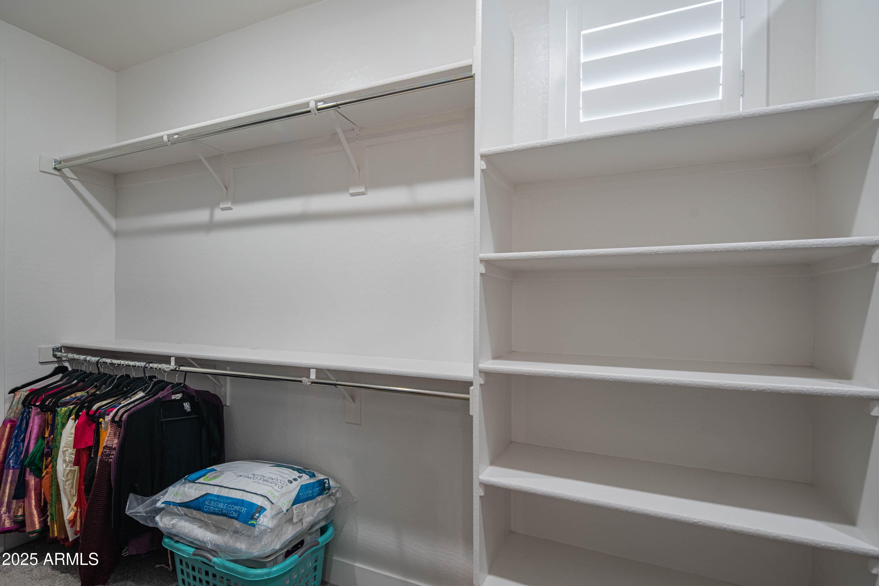 5232 South Cobblestone Street Gilbert, AZ 85298 - Photo 37 of 71 a view of walk in closet with clothes and shoes