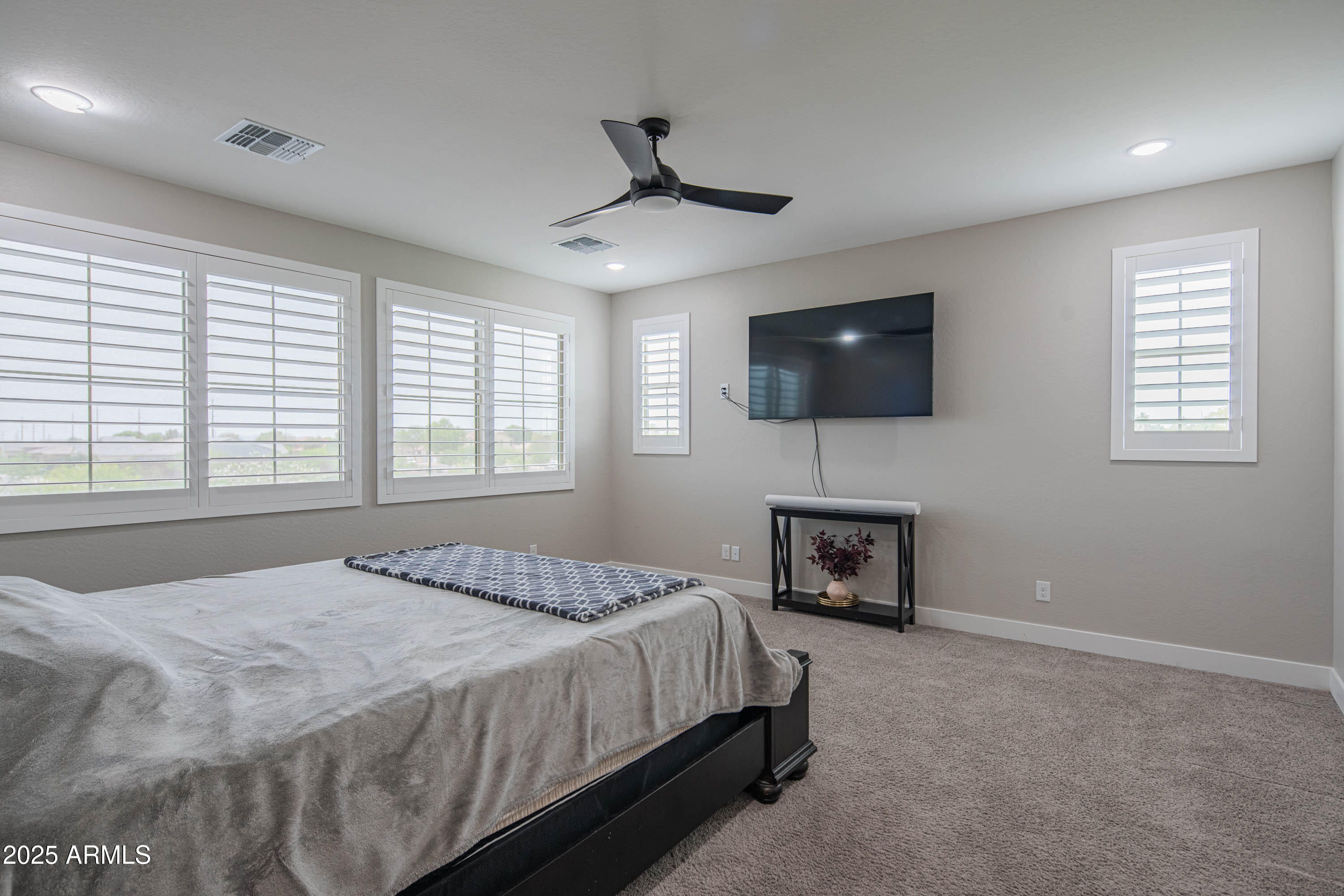 5232 South Cobblestone Street Gilbert, AZ 85298 - Photo 39 of 71 a bedroom with a bed and a television