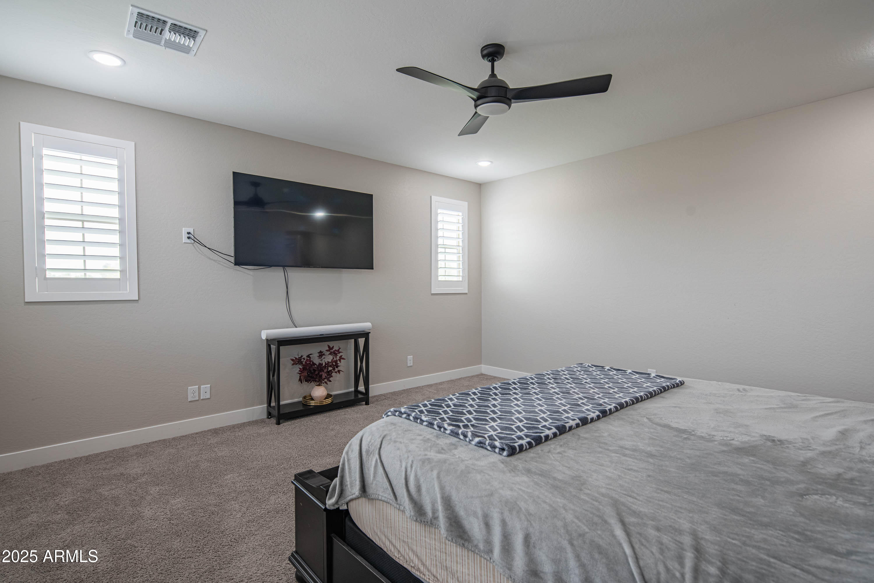 5232 South Cobblestone Street Gilbert, AZ 85298 - Photo 41 of 71 a bedroom with a bed and a flat screen tv
