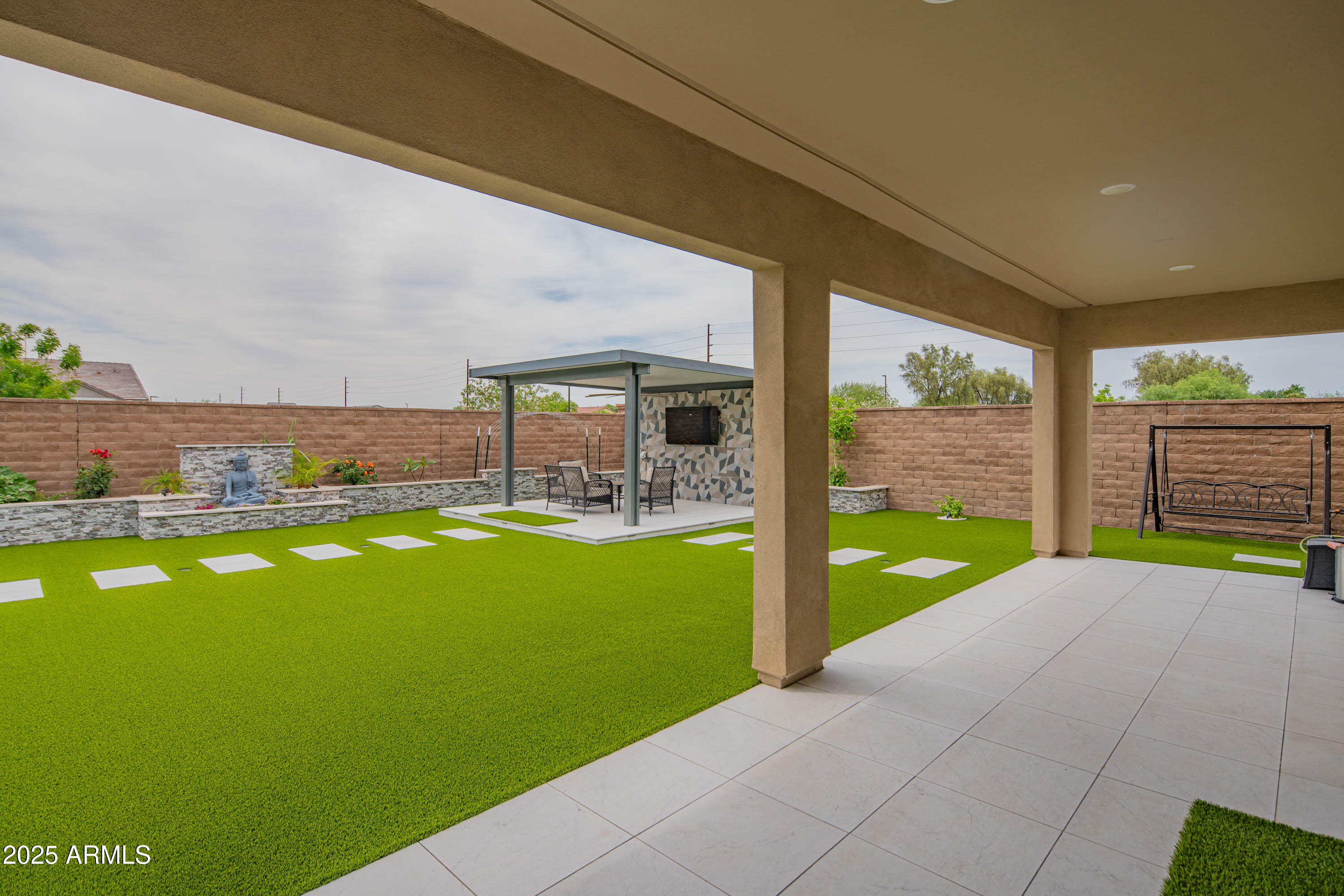 5232 South Cobblestone Street Gilbert, AZ 85298 - Photo 50 of 71 a view of a swimming pool with an outdoor seating and a garden