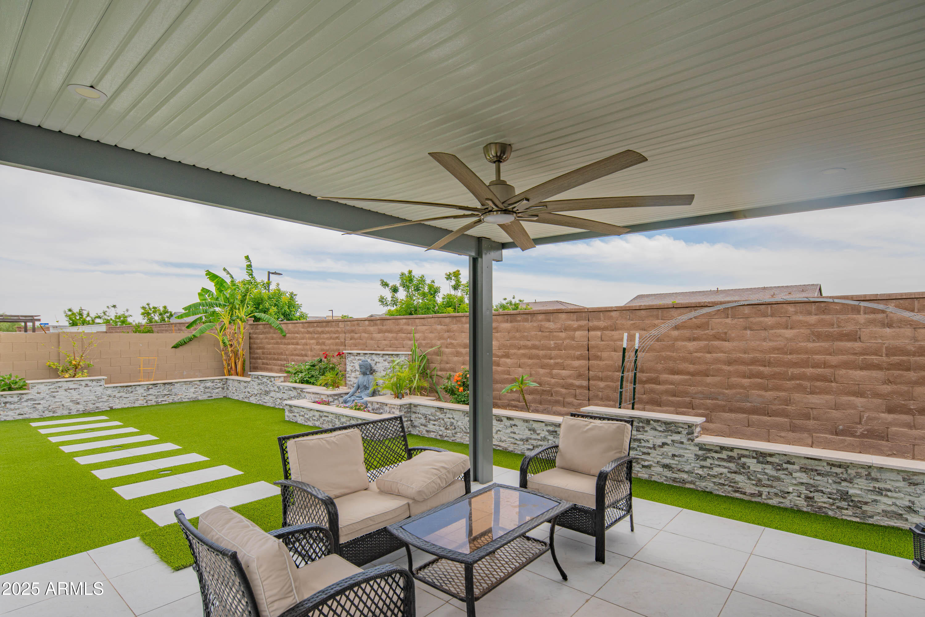 5232 South Cobblestone Street Gilbert, AZ 85298 - Photo 56 of 71 a view of a chairs and table in patio with a lake view