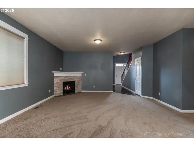 a view of an empty room with a fireplace