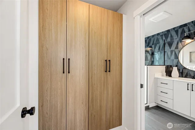 a view of a bedroom with closet and mirror