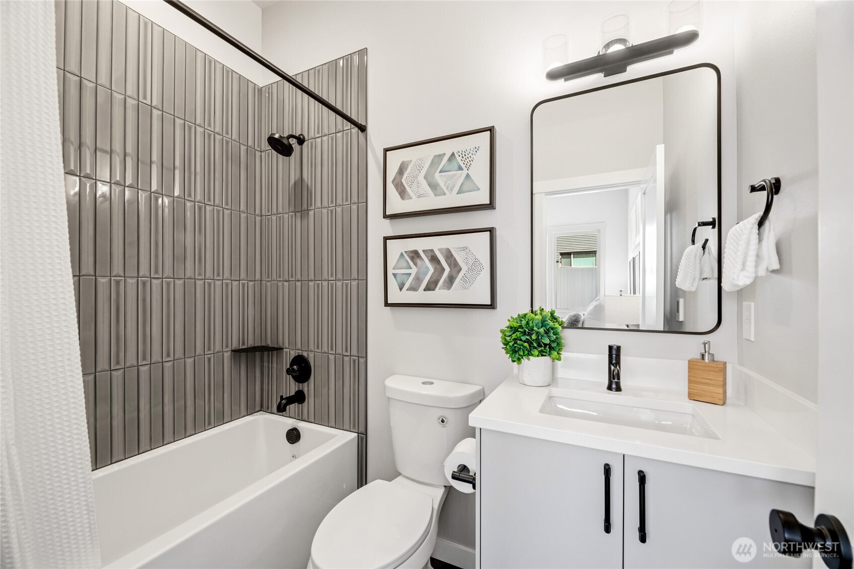 2817 Franklin Avenue East, Unit B Seattle, WA 98102 - Photo 16 of 24 a bathroom with a sink a mirror a toilet and bathtub