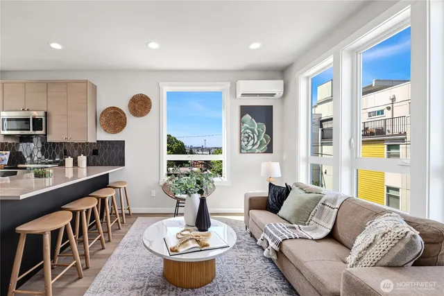a living room with furniture potted plant and a window