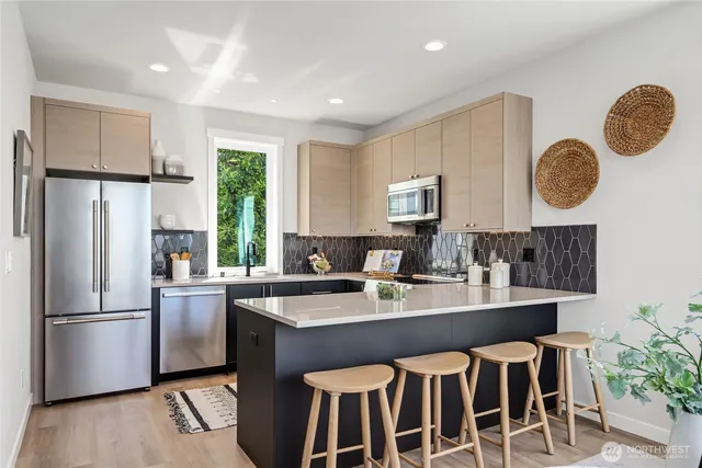 a kitchen with a sink appliances and cabinets