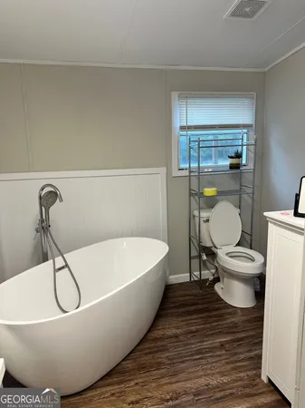 a white tub sitting next to a toilet