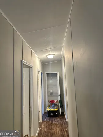 a view of a room that has a mirror and a hallway