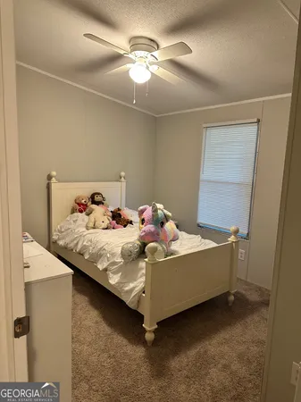 a bed sitting in a bedroom next to a window