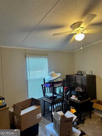 a living room with furniture a chandelier and a window