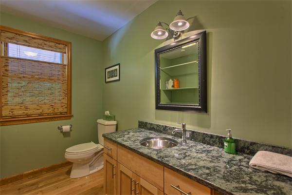 568 Lowell Road Groton, MA 01450 - Photo 8 of 16 a bathroom with a granite countertop toilet a sink and mirror