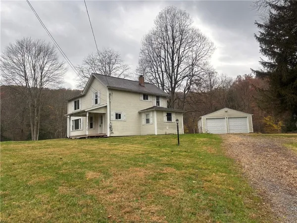 a house with huge green field in front of it