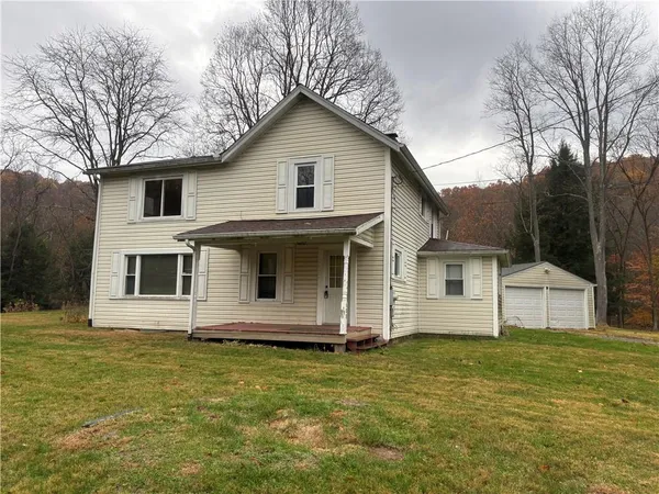 a front view of a house with a garden