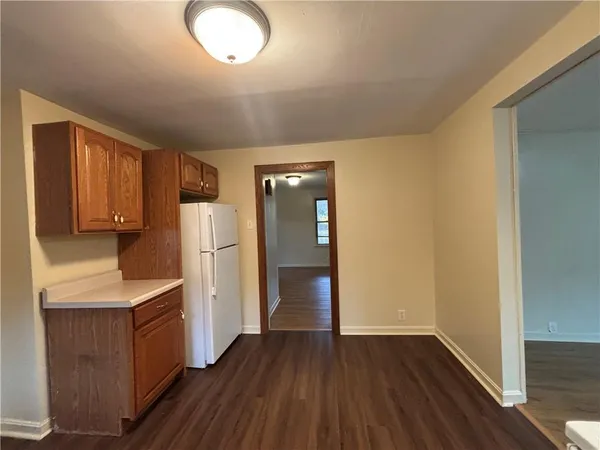 a kitchen with a refrigerator and cabinets