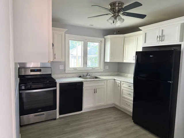 a kitchen with a sink stove and refrigerator