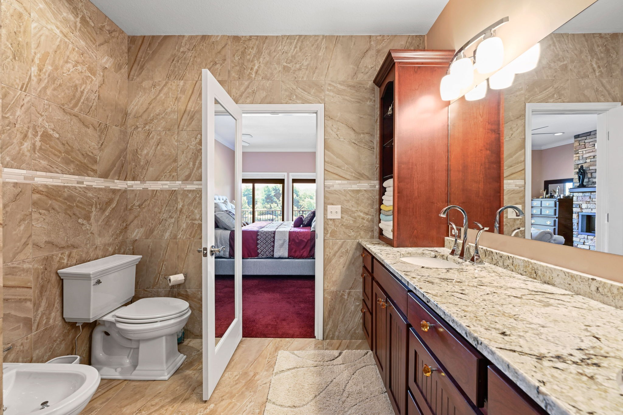 850 Sable Road Spring City, TN 37381 - Photo 23 of 56 a spacious bathroom with a granite countertop toilet a sink and a mirror
