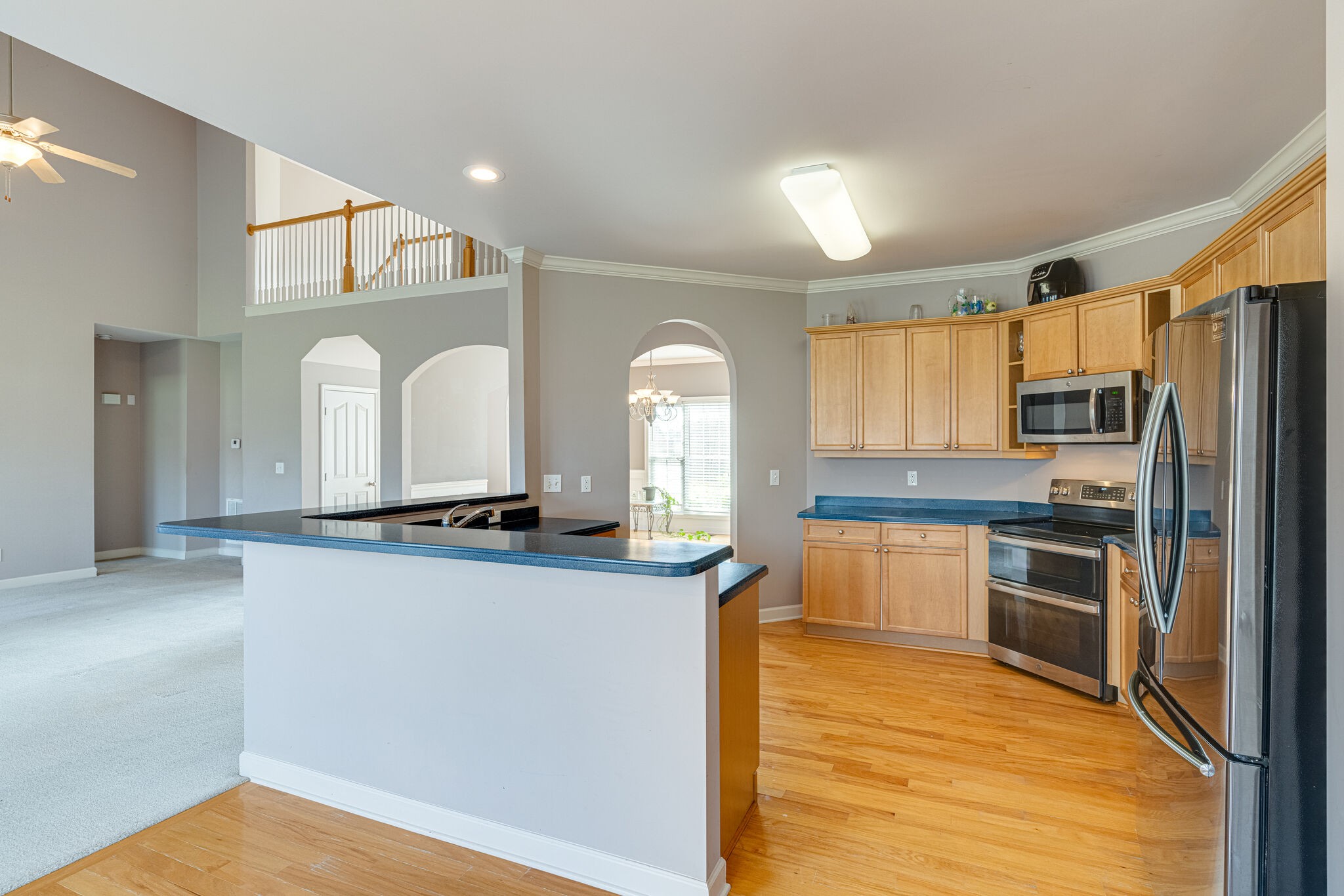 1028 Grider Drive Gallatin, TN 37066 - Photo 13 of 47 a kitchen with stainless steel appliances granite countertop a stove a sink and a refrigerator