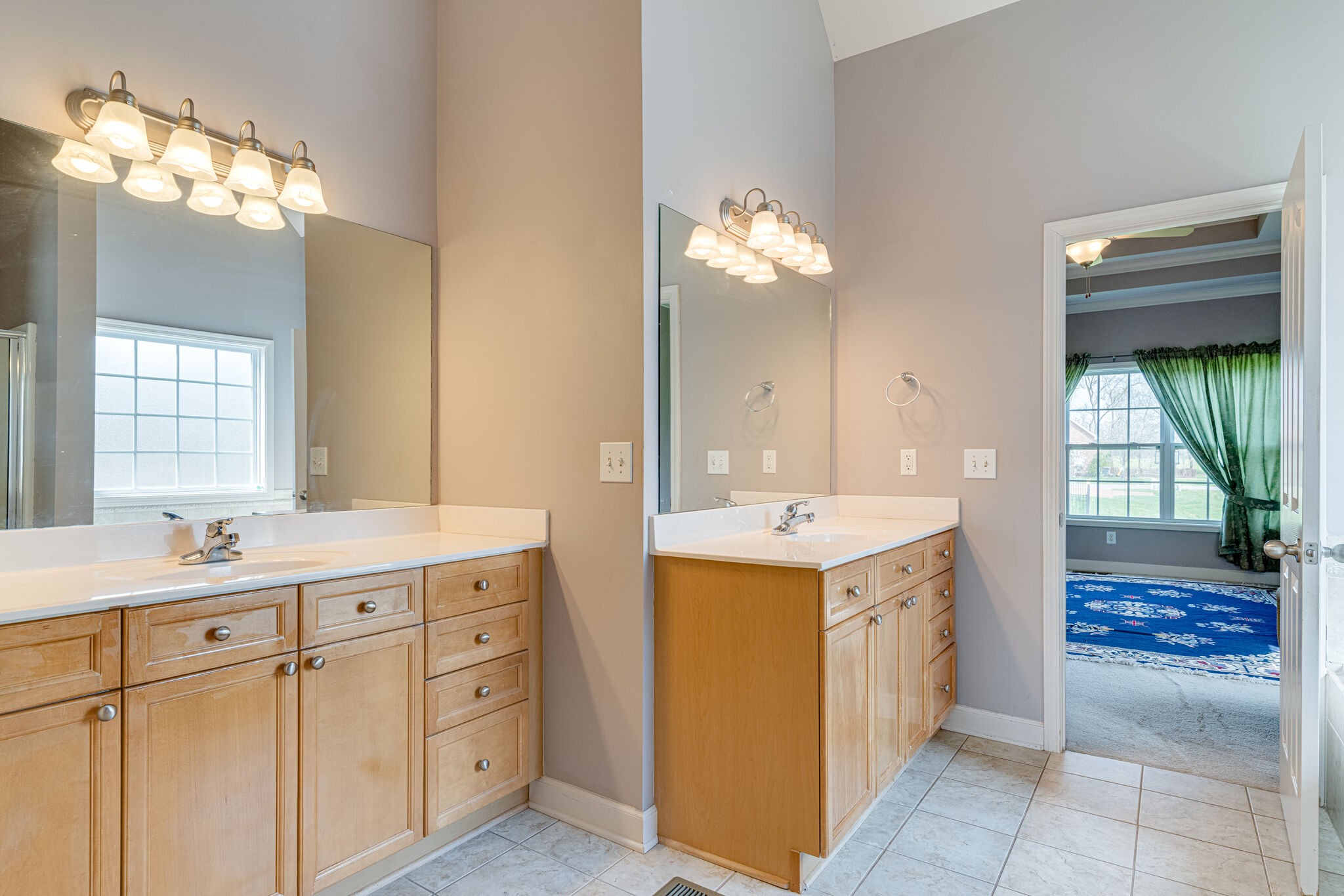 1028 Grider Drive Gallatin, TN 37066 - Photo 21 of 47 a view of a double vanity sink and a mirror in a room