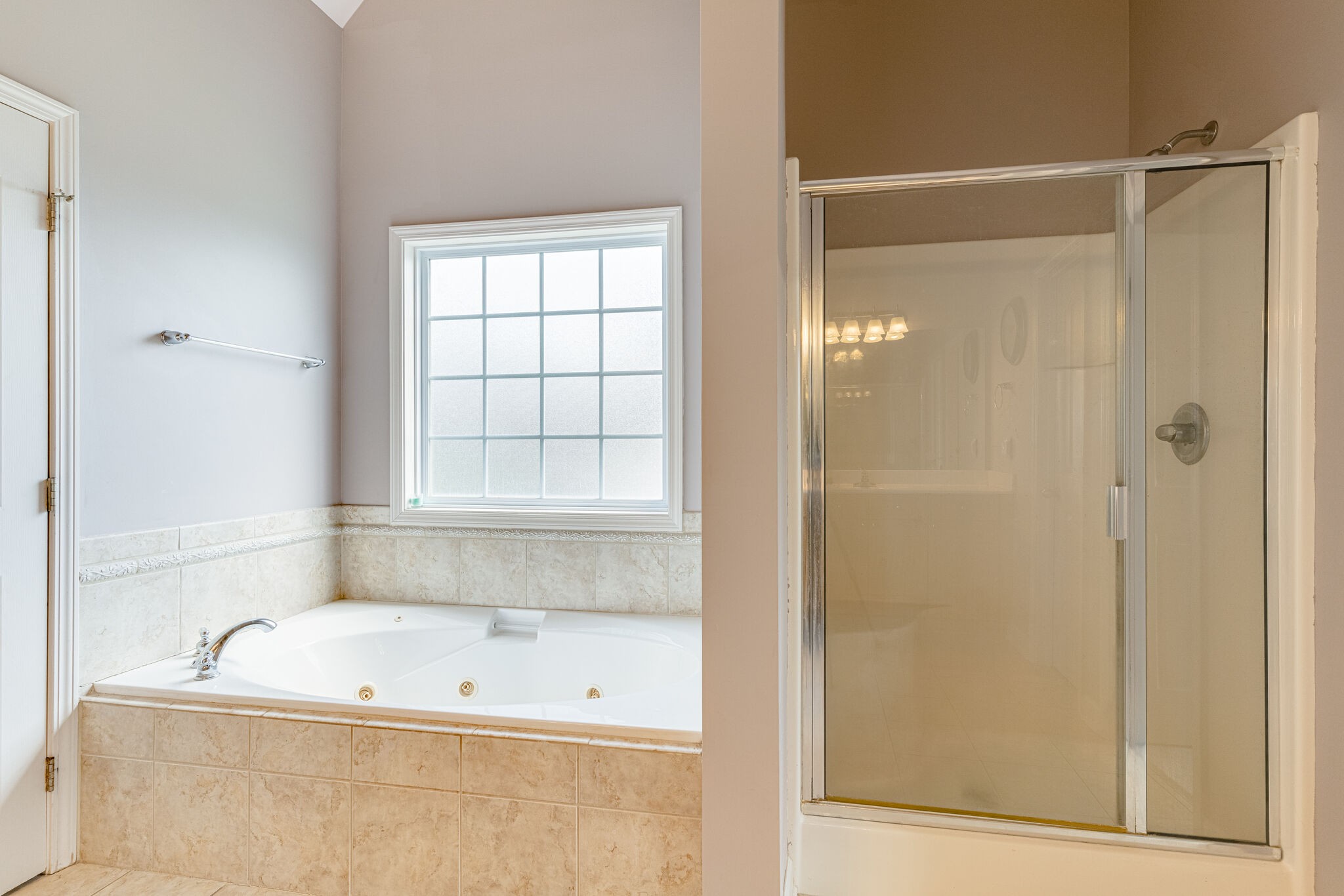 1028 Grider Drive Gallatin, TN 37066 - Photo 22 of 47 a bathroom with a tub a window and a shower