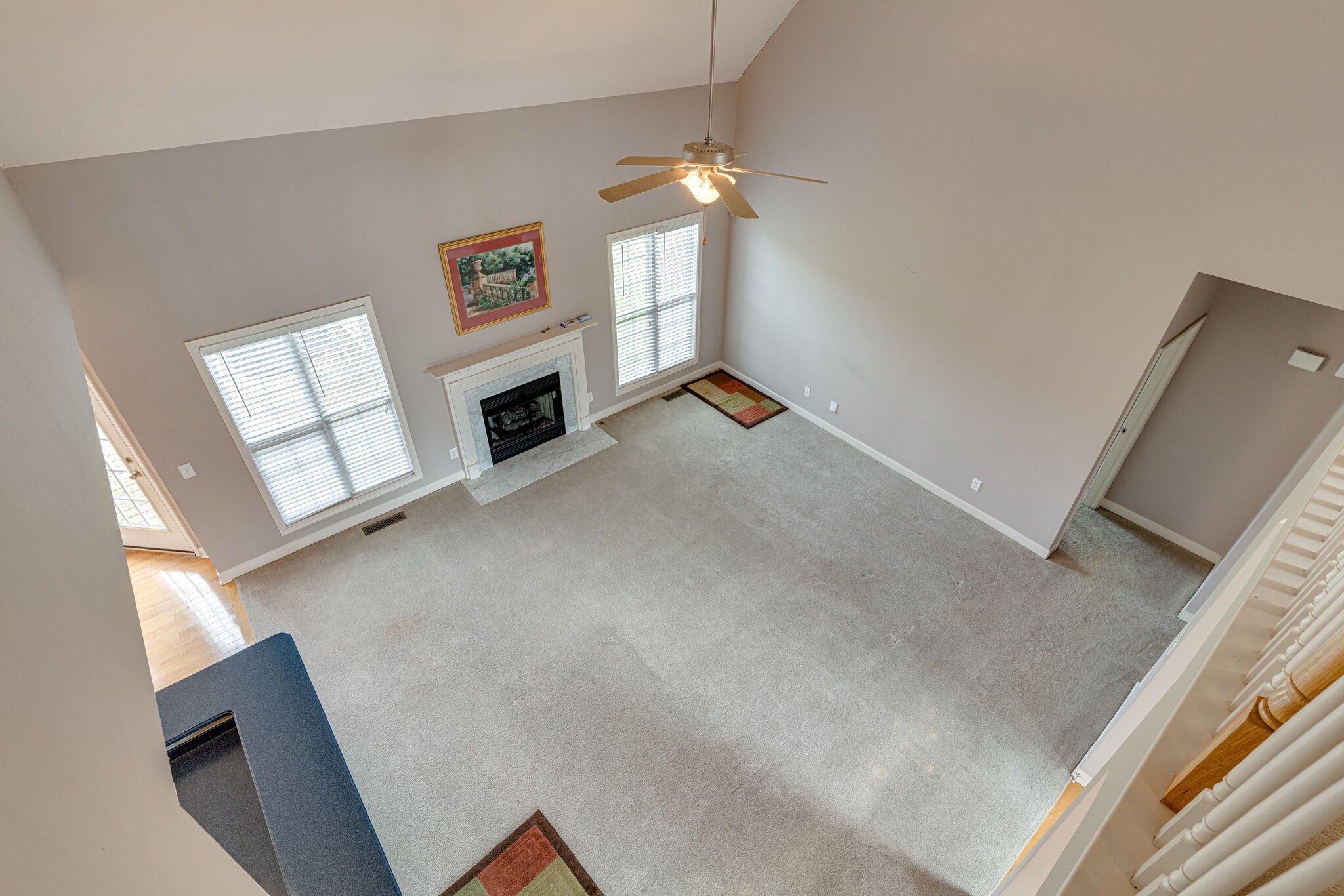 1028 Grider Drive Gallatin, TN 37066 - Photo 30 of 47 a view of a livingroom with a fireplace a ceiling fan and windows